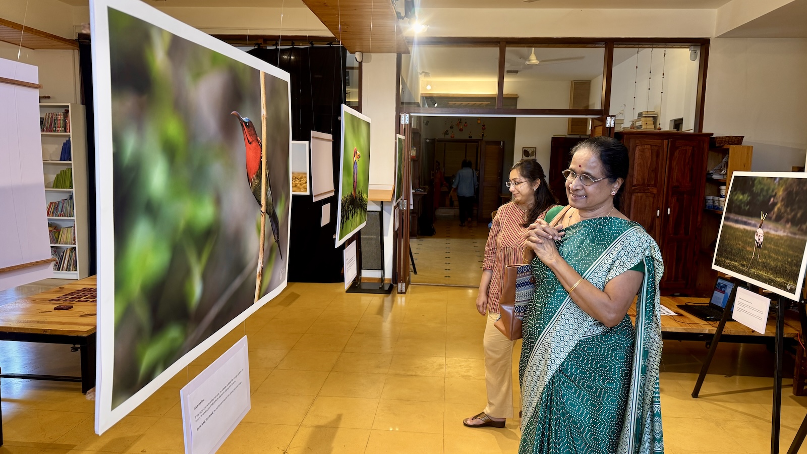 Residents viewing the bird-photography exhibition at the Courtyard Koota, Malhar